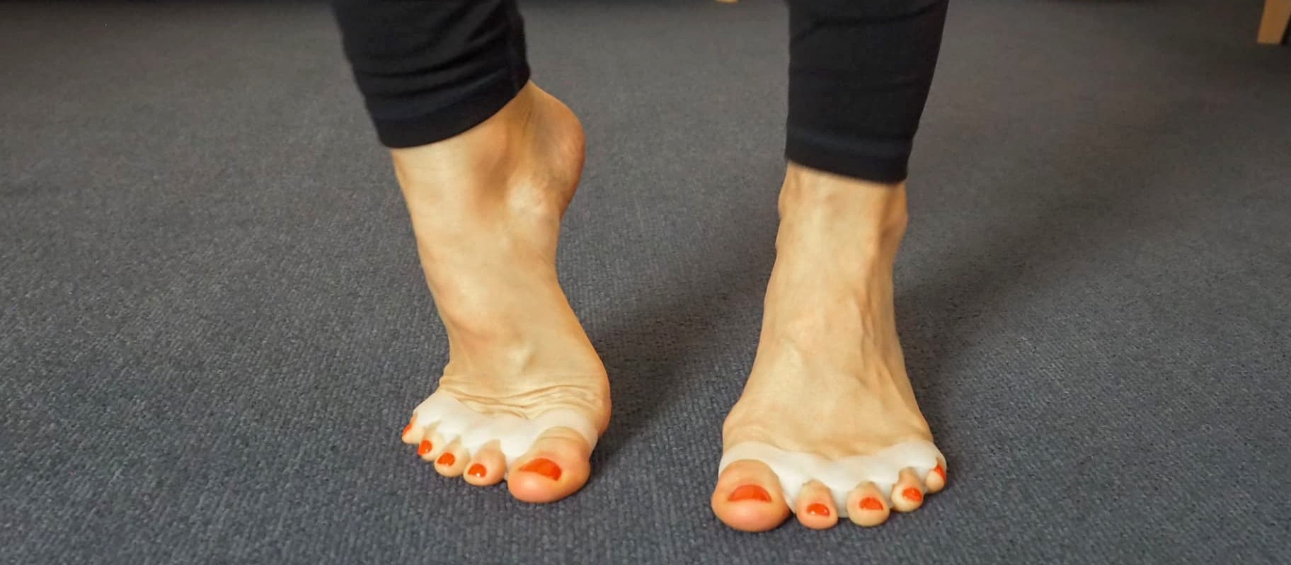 Bare feet wearing toe spacers during a myofascial movement session focused on foot function